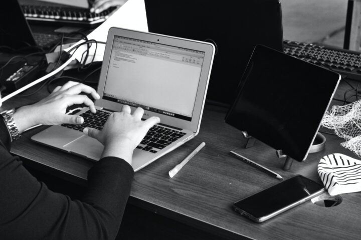 Set of hands typing on laptop